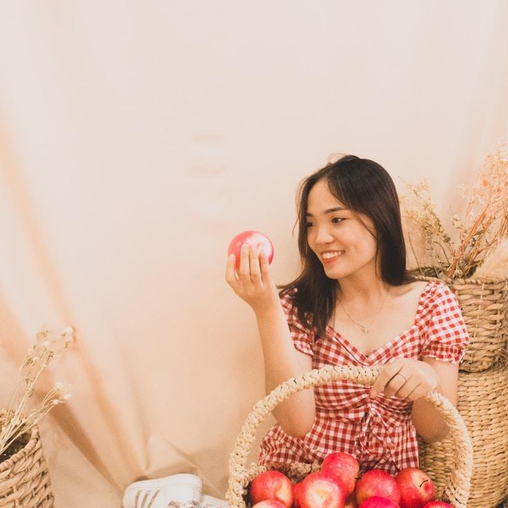 Ariana Kapoor, Lead Design Curator at Spruce Parcel Linen, reviewing corporate floral arrangements